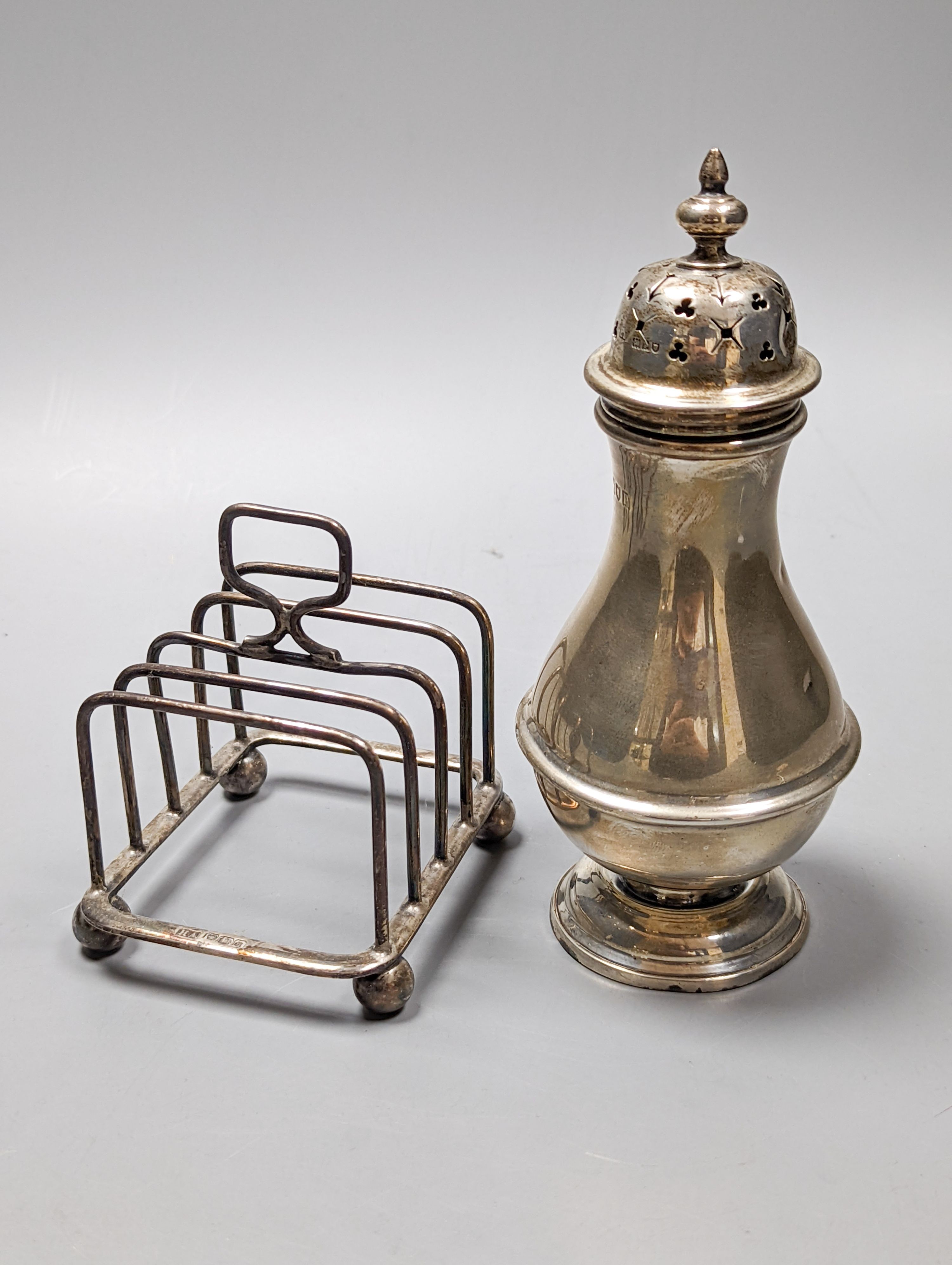 A George V silver sugar caster, London, 1910, 16.6cm and a small silver five bar toastrack, 8oz.
